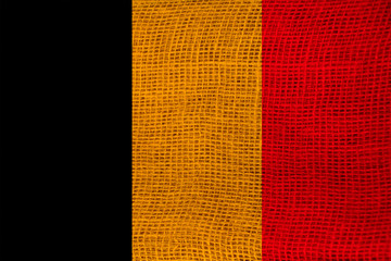 photo of the national flag of Belgium on a luxurious texture of satin, silk with waves, folds and highlights, close-up, copy space, travel concept, economy and state policy