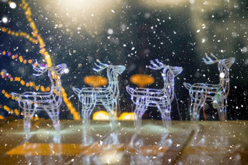Defocused Christmas themed background with snowflakes. Christmas market theme.