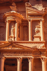 The beautiful decorations of the facade of the Treasury (Al Khazneh) temple, Petra, Jordan, bathed by early morning sun.