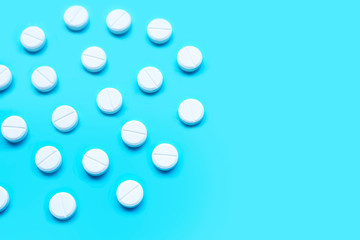 Tablets of Paracetamol on blue background.