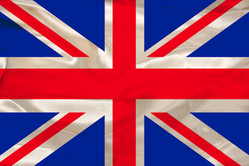 beautiful photo of a colored national flag of the modern state of Great Britain on a textured fabric, concept of tourism, emigration, economy and politics, close up