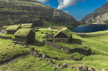 Nordic natural landscape, Saksun, Stremnoy island, Faroe Islands, Denmark. Iconic green roof houses.