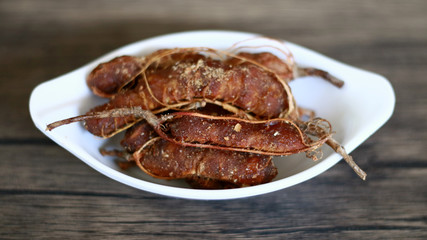 Tamarind or Tamarindus indica on wood background.  