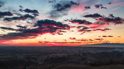 Naklejka na ściany i meble Colorful sunset in the italian vineyards