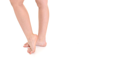 Low section close-up of slim female legs and feet on white background