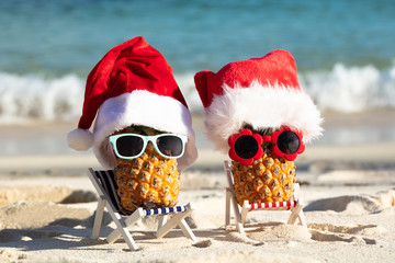 Two Pineapples With Santa Hats And Sunglasses