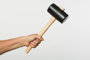 hand holding a rubber hammer