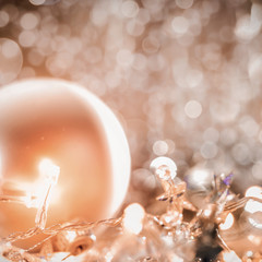 Christmas decorations in bright gold shiny colors with Christmas lights with blurred background.