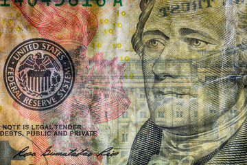 Close-up at president Hamilton eyes, highly magnified surface of used 10 dollars note with visible details of cotton fiber paper, with all flaws, watermarks and traces of usage.