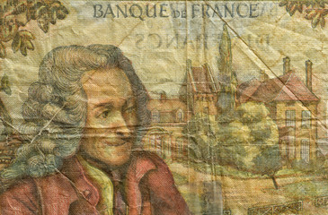Close-up at an ancient, outdated ten Francs French banknote. Details of fiber paper, with all flaws, watermarks and traces of usage.