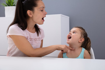 Speech Therapist Helps The Girl How To Pronounce The Sounds