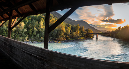 View over The Inn River In Hall in Tirol in Direction Innsbruck at sunset - obrazy, fototapety, plakaty