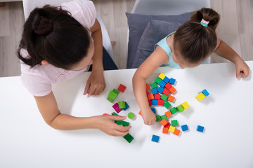 Daycare Worker Playing With Colorful Wooden Toy Blocks