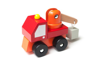 Closeup of miniature toy, wooden red truck with carrycot on white background