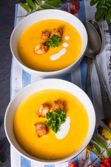 Delicious pumpkin soup with croutons and coconut milk