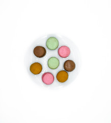 macarons on plate, sweet colorful macarons on white background