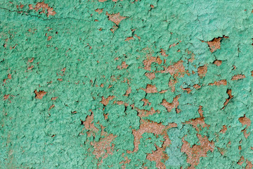 green peeling paint on a wooden board