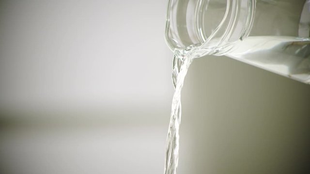 Close up pouring fresh water from jar