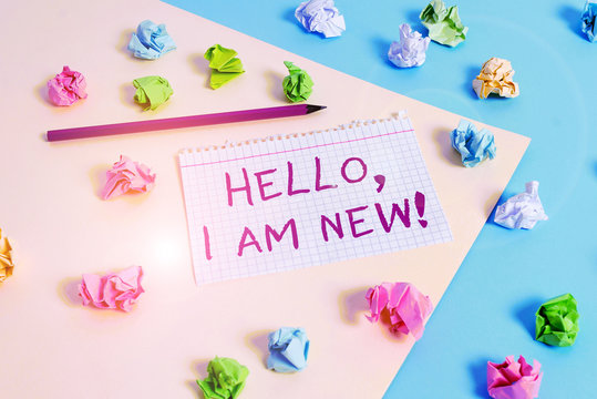 Text sign showing Hello I Am New. Business photo text introducing oneself in a group as fresh worker or student Colored crumpled papers empty reminder blue yellow background clothespin