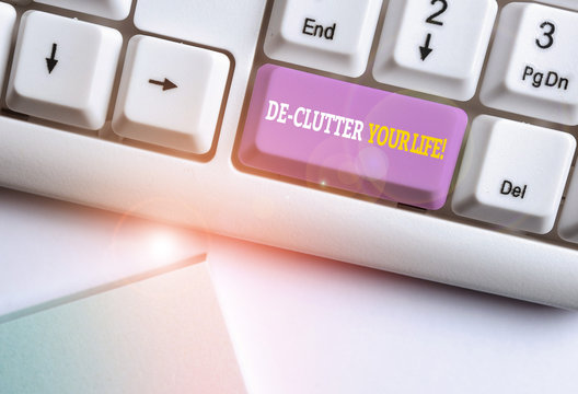 Word writing text De Clutter Your Life. Business photo showcasing remove unnecessary items from untidy or overcrowded places White pc keyboard with empty note paper above white background key copy