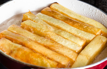 Raw fries fries raw on a white plate isolate