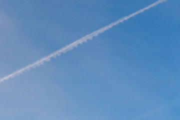 Blue sky with Condensation Trails by jet engine.