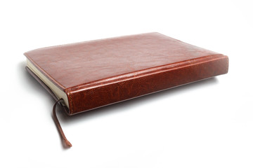 Brown leather notebook on a white background isolate