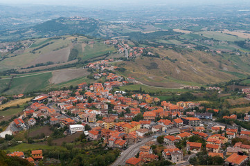 Fototapeta na wymiar Aerial view of countryside village with red rooftops and vast farmlands