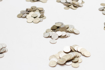 coins divided in piles on a white background