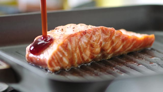 Cooking food, Pouring sweet sauce onto grill salmon fish
