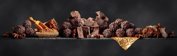 Chocolate with ingredients and spices on a dark background.