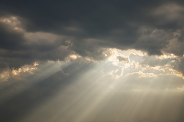 a beam of sunlight breaks through a dense cloud