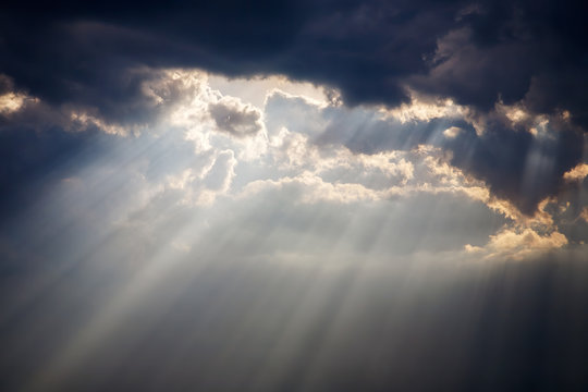 a beam of sunlight breaks through a dense cloud © Viktor