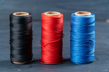 thread coils black red and blue