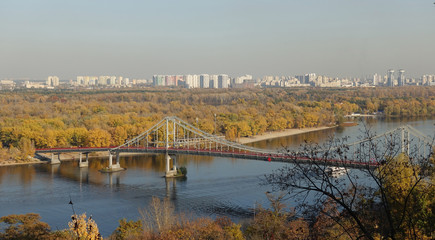 View of the pedestrian bridge and the Dnieper river in Kiev on a sunny autumn day