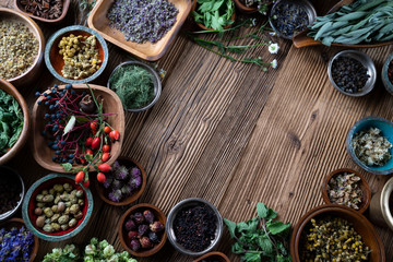 Set of colorful spices in different bowls on wooden table