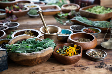 Set of colorful spices in different bowls on wooden table