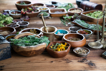 Set of colorful spices in different bowls on wooden table
