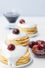 Pancakes with cream and plum jam. Selective focus.