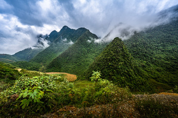 Naklejka premium Mountain road in beautiful valley. Ha Giang province. Vietnam