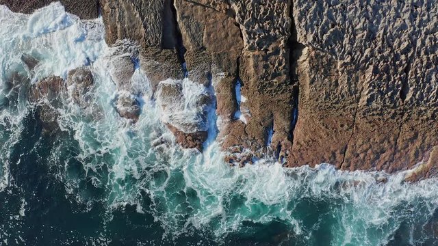 Detail of sea waves breaking in the reefs and coast, Cantabrian sea, Spain - drone aerial view