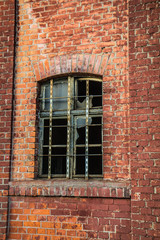 Fototapeta na wymiar Broken window of an old brick building