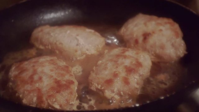 juicy meatballs fried in a metal pan.close-up.shallow depth of field.