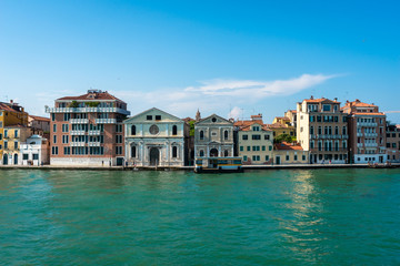 Obraz premium Venice. Vacation in Italy. Panoramic view of Venice from the Grand Canal. Venetian old colorful buildings on blue sky background. Boat trip through the canals of Venice. Travel, Tourism, Holidays.