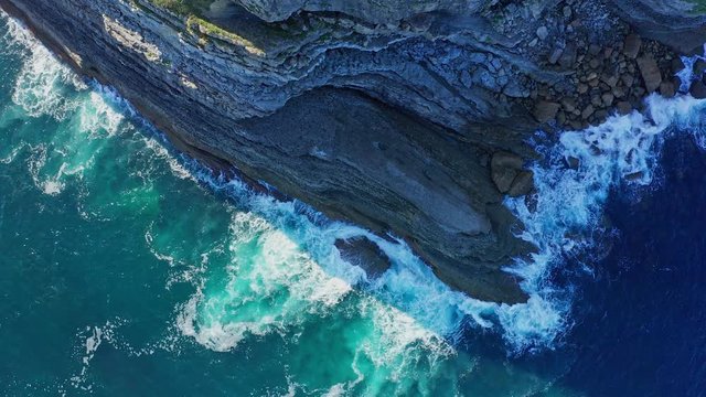 Static shot over sea waves breaking in the reefs and coast, Cantabrian sea, Spain - drone aerial view