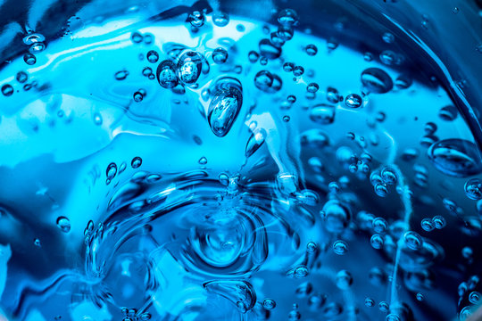 Water blue gel balls. Polymer gel. Silica gel. Balls of blue hydrogel. Crystal liquid ball with reflection. Texture background. Close up macro. Soapsuds background with air bubbles