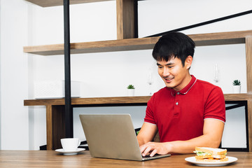 Breaking Time Young Asian Architect sitting in coffee shop and drinking a cup of coffee after meeting with customers and working hard for his Business Target Achievement.