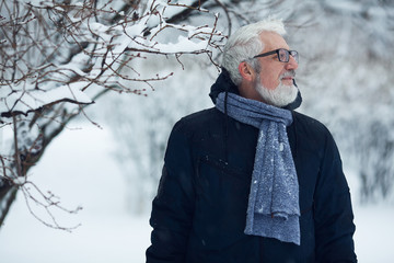 Active grandpa concept. Portrait of handome mature man in trendy winter clothing and fashionable...