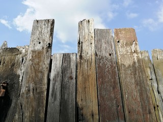 Wood fence with bright sky in the background.  Wood texture.  Grunge wood plank, timber, wood board.