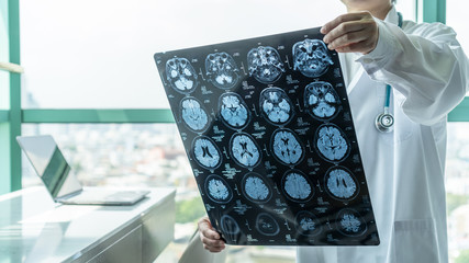 Brain disease diagnosis with medical doctor seeing Magnetic Resonance Imaging (MRI) film diagnosing...
